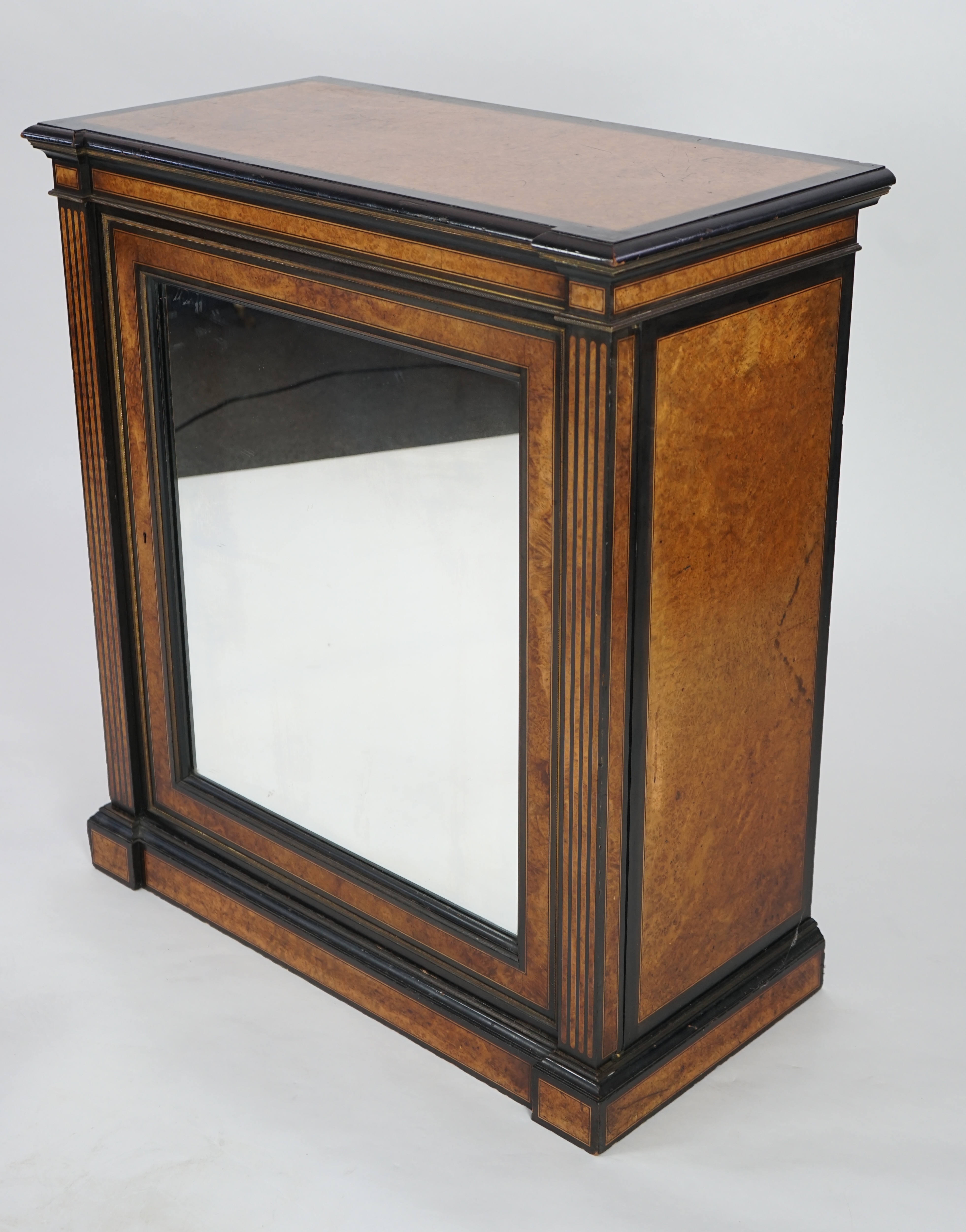 A Victorian ebony banded amboyna wood collector's cabinet, by Holland & Sons, with inverted breakfront top and single mirrored door enclosing four frieze and two banks of thirteen graduated drawers fitted with recessed b